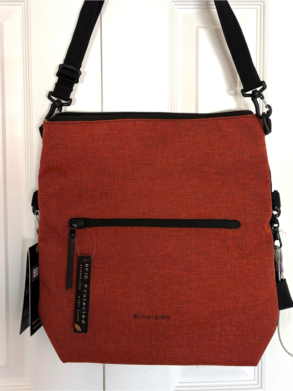 Sherpani Rust Orange Crossbody Bag with Black Strap